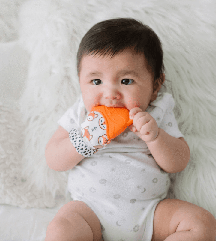 Child using Itzy Ritzy Teether Itzy Mitt™ Silicone Teething Mitts - Fox