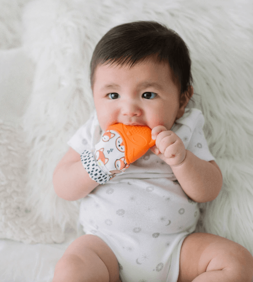 Child using Itzy Ritzy Teether Itzy Mitt™ Silicone Teething Mitts - Fox